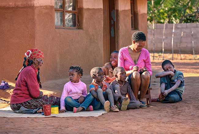 low income country, image of people sitting on ground